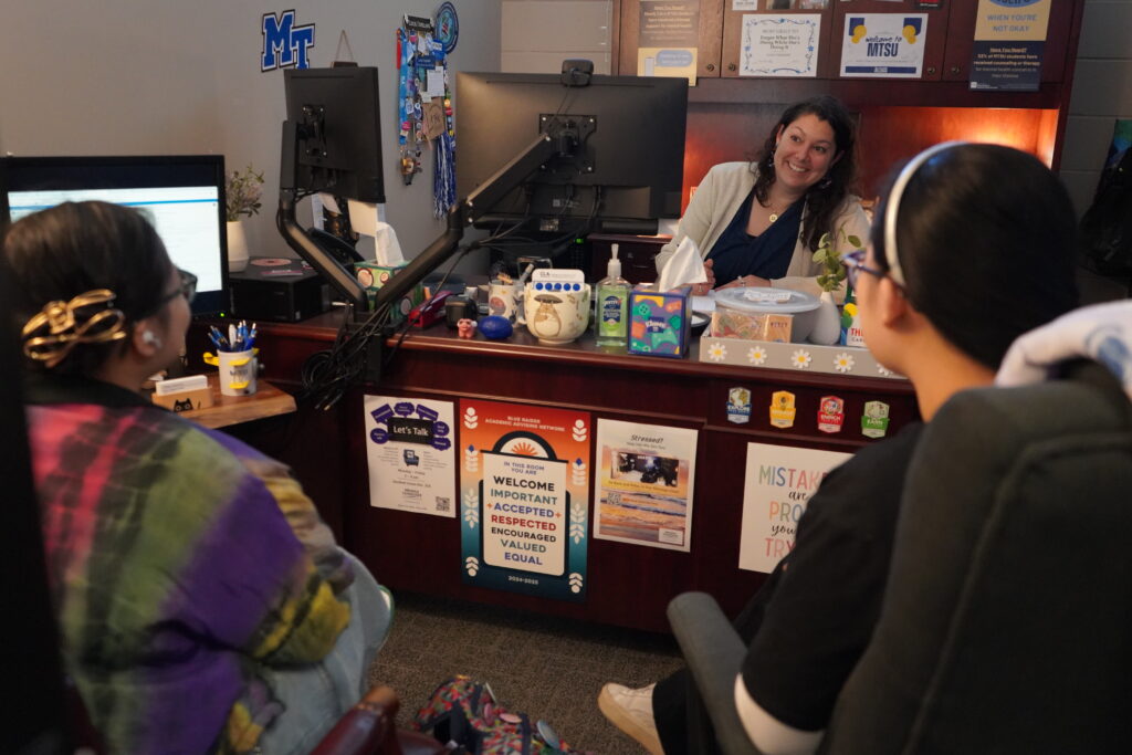a CLA advisor meets with two CLA students to discuss their course schedule.
